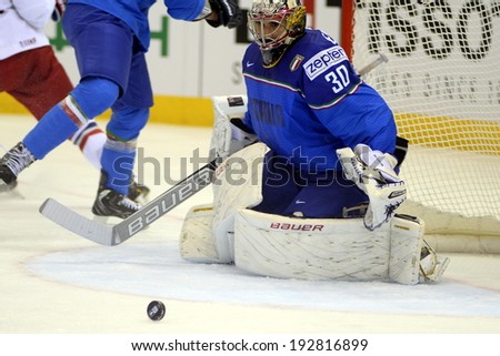 MINSK, BELARUS - MAY 14: Italy\'s Bellissimo Daniel #30 save the puck during preliminary round action at the 2014 IIHF Ice Hockey World Championship on May 14, 2014 in Minsk, Belarus.