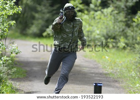 ZASLAWYE, BELARUS - MAY 17: Player run with gun during Laser Tag IT-CUP tournament at abandoned summer camp on May 17, 2014 in Zaslawye, Belarus.
