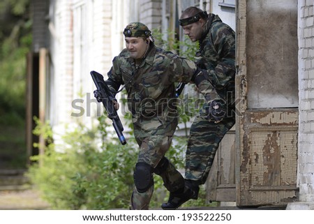 ZASLAWYE, BELARUS - MAY 17: Players run with gun during Laser Tag IT-CUP tournament at abandoned summer camp on May 17, 2014 in Zaslawye, Belarus.