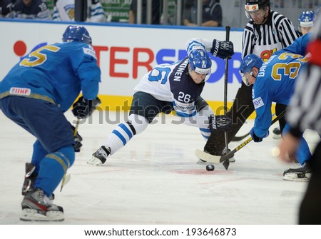 MINSK, BELARUS - MAY 19: IMMONEN Jarkko of Finland and GAVRILIN Andrei (33) of Kazakhstan battle for the puck during 2014 IIHF World Ice Hockey Championship match on May 19, 2014 in Minsk, Belarus.