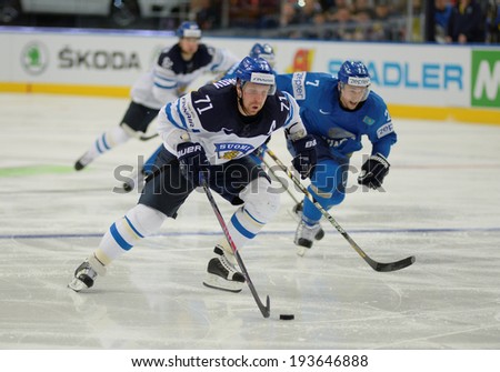 MINSK, BELARUS - MAY 19: KOMAROV Leo (71) of Finland and SEMYONOV Maxim (7) of Kazakhstan battle for the puck during 2014 IIHF World Ice Hockey Championship match on May 19, 2014 in Minsk, Belarus.