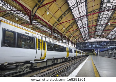 Train Station - Stock Image. Modern Commuter Train inside the Victoria Railway Station in London, Europe.