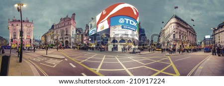 LONDON, ENGLAND NOV 28: Famous Piccadilly Circus neon signage become a major attraction of London on on Nov 28, 2013 in London, United Kingdom. Panorama of new Piccadilly advertisement lights, VINTAGE