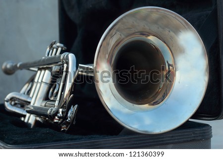 Silver trumpet in the black box