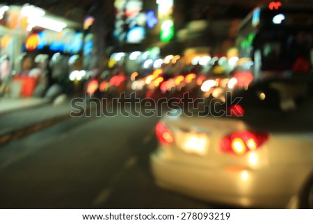 Blurred bokeh of car in city at night