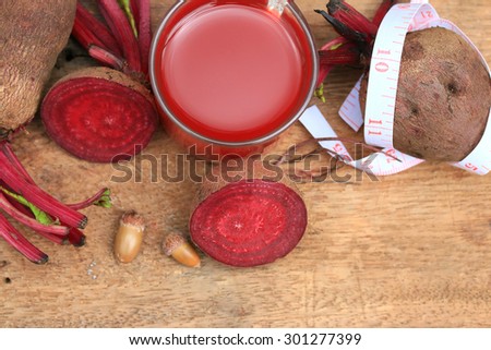 fresh vegetables beetroot juice and a tape measure