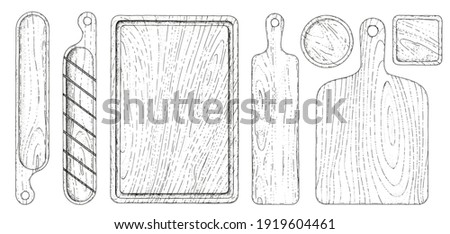 Vector set of different cutting boards. Hand-drawn sketches engraving style. Collection of wooden tableware. Wooden boards for cutting baguette and bread. Isolated objects on a white background