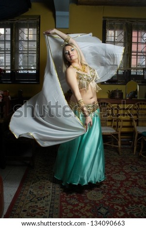 Beautiful  blonde in the belly dance with veil
