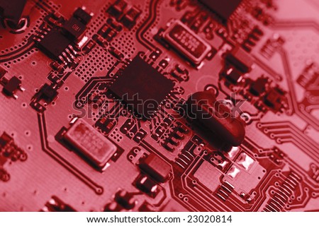 Fragment of the electronic circuit - red computer board with chips and components