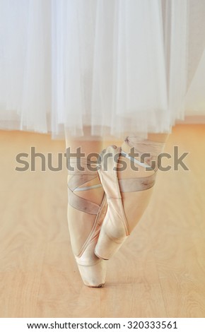 feet and legs of ballerina in pointe shoes