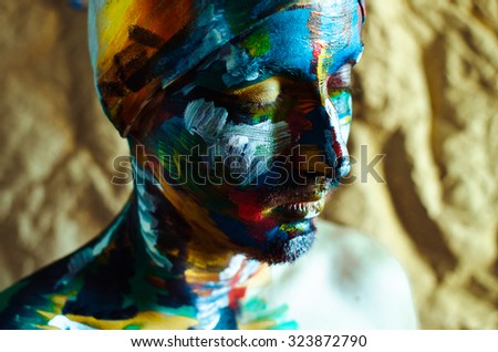 Artistic colorful portrait of a   model man with big blue eyes and creatively painted face