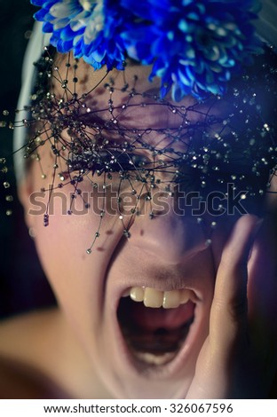 shouting emotional woman with blue flowers and tiny beads decor in her head