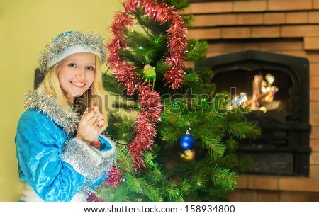 Snow maiden sitting by the fireplace