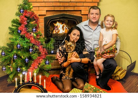 Friendly Family with a Christmas tree and a fireplace