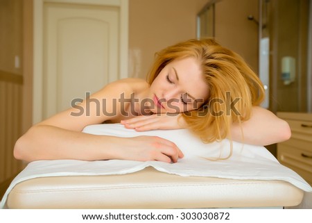 Beautiful blonde Girl lies on a massage table. fell asleep