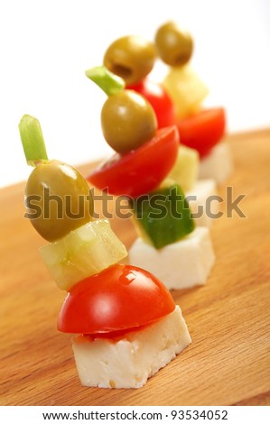 Canape platter with cheese, cucumber,tomato,olives. Shallow depth-of-field.
