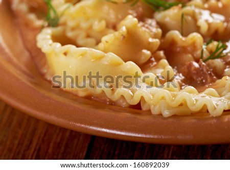 Italian pasta mafalde with  beef ,sour cream and  tomato sauce .Shallow dof