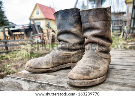 Old Muddy Farmers Boots On Background Wooden Wall Stock Photo 163239770 ...