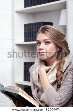 The young woman reads the book