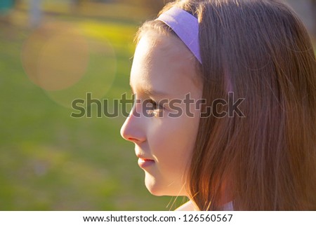 Profile face Of A Beautiful young Girl Against The Light