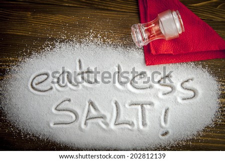 Eat less salt written on a heap of salt - anti-hypertensive campaign