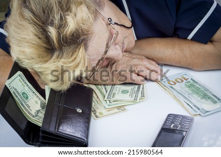 Woman pensioner count money and get tired