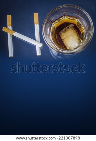 Cigarettes and glass of alcohol forming the word NO on blue background with copy space - Health concept - Anti smoking and anti alcoholism campaign