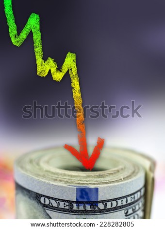 Stack of money with colorful arrow pointing down showing decrease - Financial concept