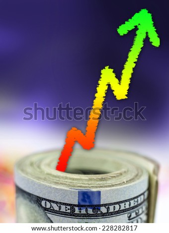 Stack of money with colorful arrow pointing upwards showing growth - Financial concept