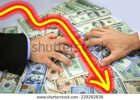 Breaking the partnership - Business Men\'s hands grabbing over money and arrow pointing down showing bad financial condition