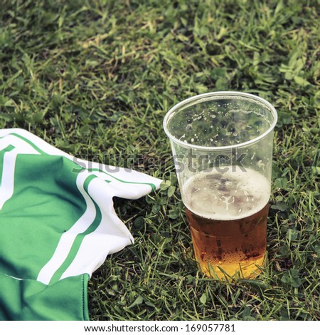 Beer and football dress on grass
