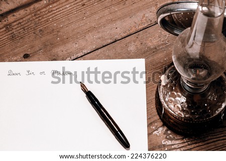 Old fashioned letter with a pen and lamp