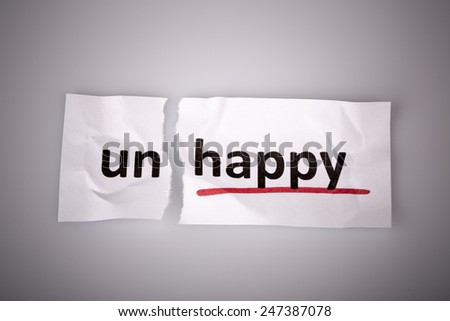The word unhappy changed to happy on torn paper and white background