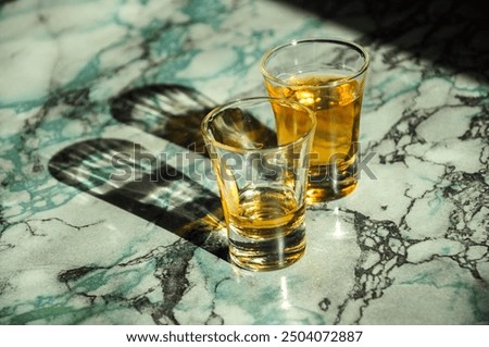 Similar – Image, Stock Photo Glasses of whiskey casting shadows on table