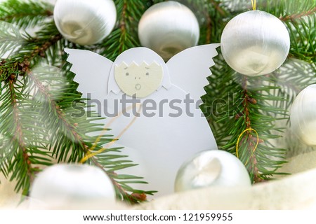 Christmas card with paper angel, balls and spruce twig
