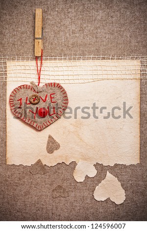 Art greeting card on vintage background with heart, old paper, fabric and words I Love You