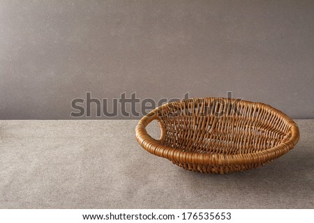 Wicker empty basket on a grunge background