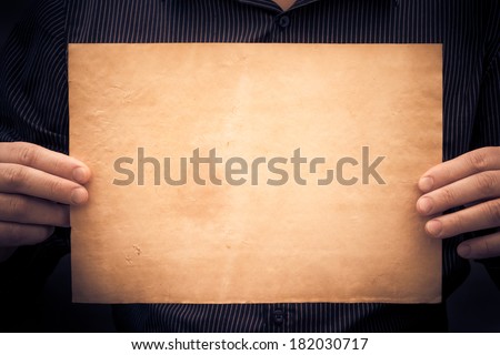 Old sheet of paper in the hands of a man