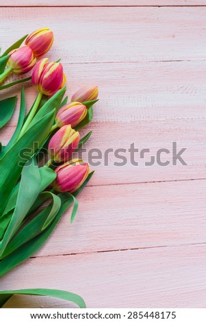 Art abstract background with spring tulips on wooden for design