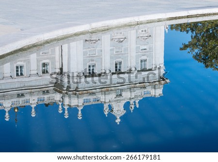A corner of the Palacio Real de Madrid--the official residence of the Spanish Royal family--reflected in the fountain\'s pool.