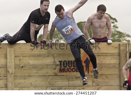 Boughton House Northamptonshire/UK-May 4, 2013: Tough Mudder challenge and obstacle course raising funds for Help for Heroes.  Participants clear the first hurdle.