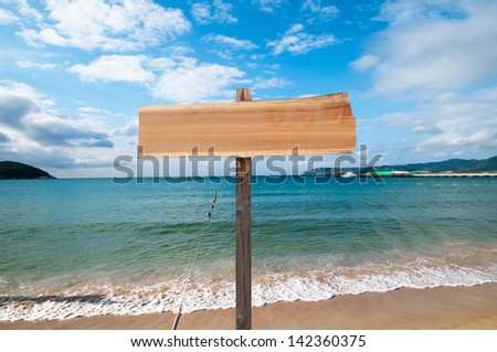 wood sign with ocean background