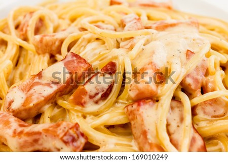 Spaghetti alla Carbonara made with eggs, bacon, cheese, black pepper and noodles