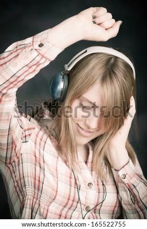 young beautiful woman listening music and dance.