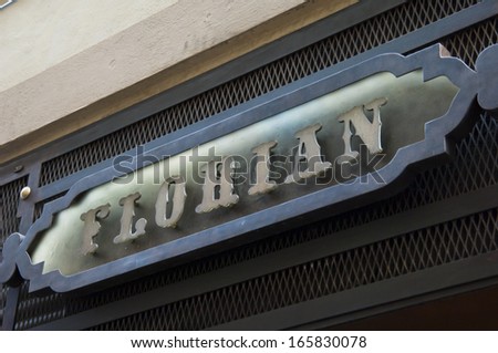 Florence, ITALY - December 8, 2011: Florian Florence Store Logo Italy mounted on the marble wall of Louis Vuitton Store at Via del Parione, the heart of Florence high-class shopping district