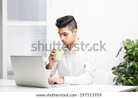 Young Asian Indian Businessman working on laptop