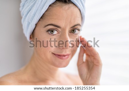 attractive woman in her forties removing make up