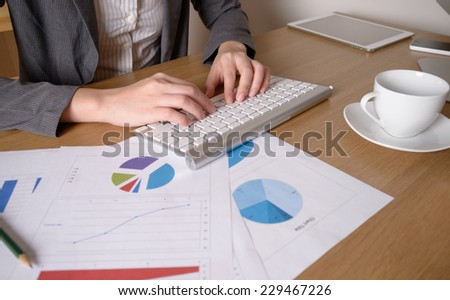 Business woman typing on computer keyboard