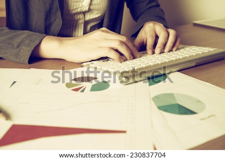 Business woman typing on computer keyboard with vintage style