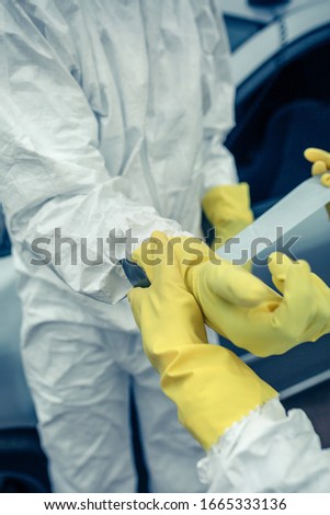 Similar – Woman taping bacteriological protective gloves to a man